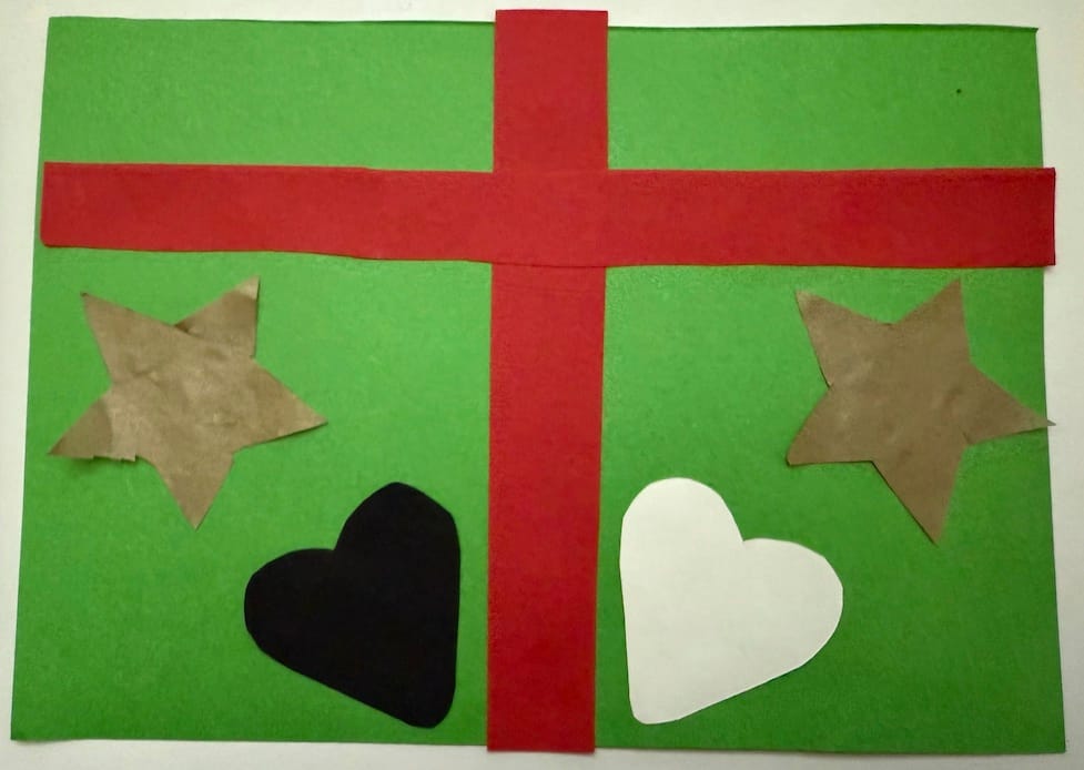 Green rectangle with bright red cross-shaped ribbon. On the left is a gold star shape and a black heart shape. On the right is a white heart shape and gold star shape 